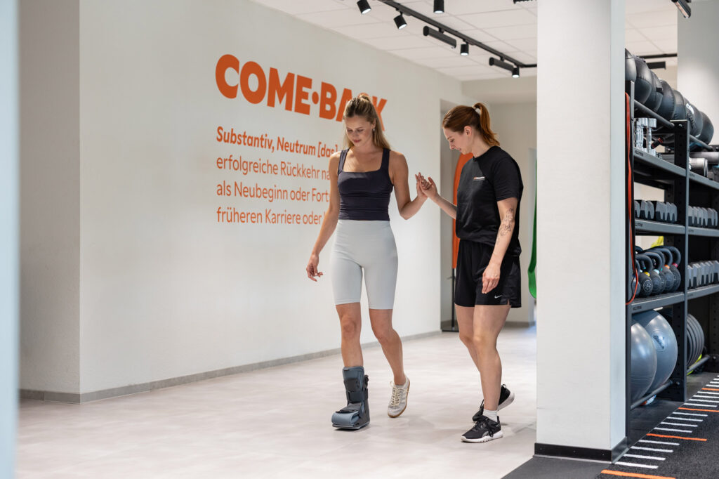 A physical therapist helps a person walk